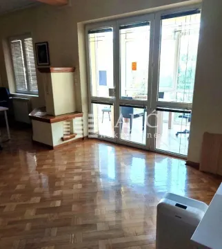 Spacious living room with wooden flooring and large glass balcony doors. - image 3