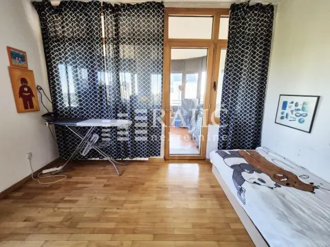Furnished bedroom with a bed and wooden floor. - image 11