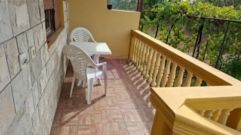 Covered balcony with patio furniture and a view of the yard. - image 3
