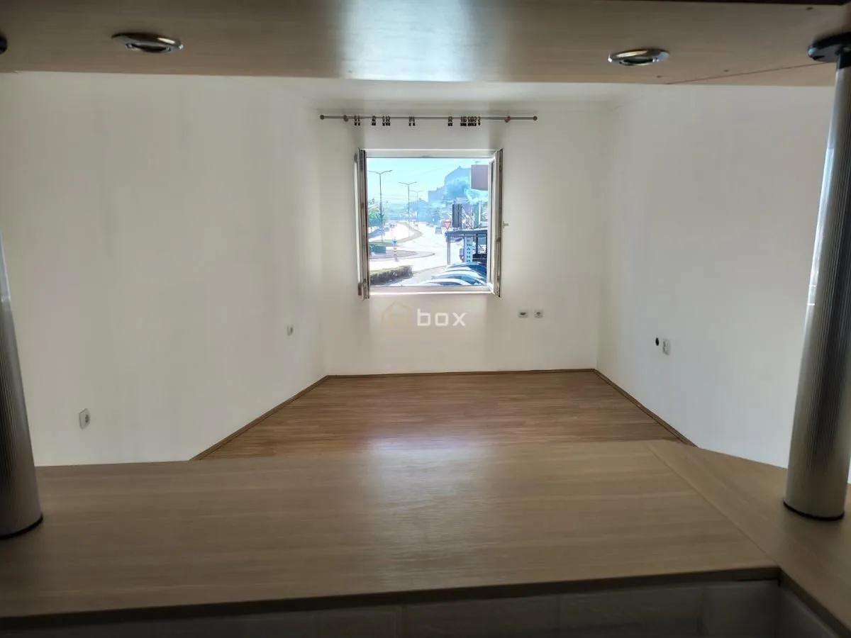 View from the interior of the property through the window towards the street and surroundings.
