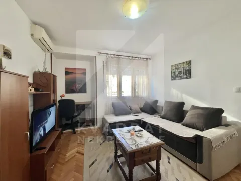 Living room with a sofa set, television, and a desk. - image 3
