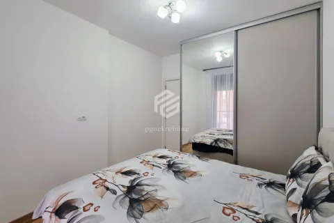 Bedroom with a double bed and a fitted wardrobe with a mirror. - image 3