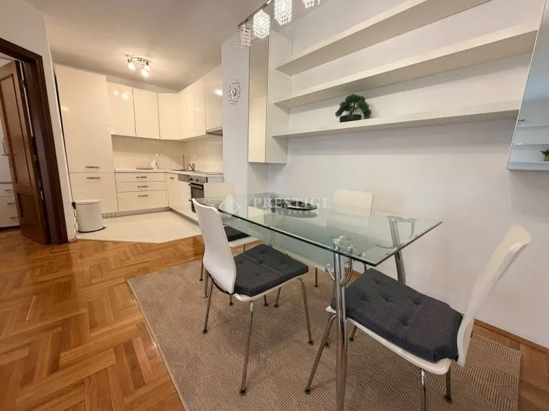 Living room with dining area and open kitchen.