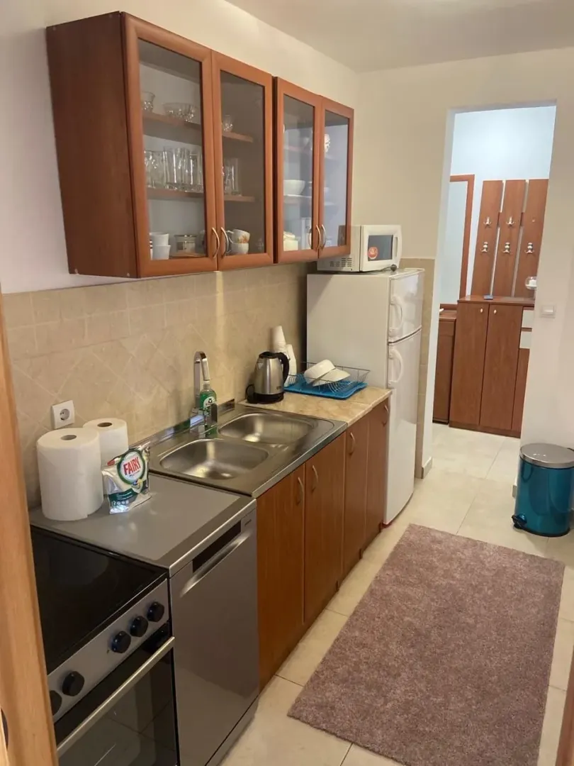 Small kitchen with wooden cabinets and appliances.