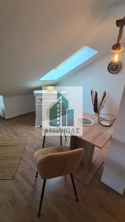 Dining area with a table and chairs in the attic.