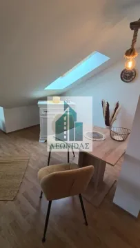 Dining area with a table and chairs in the attic. - image 13