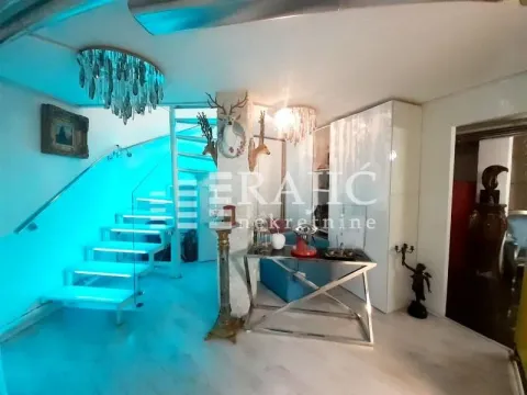Living room with staircase and modern lighting. - image 6