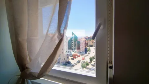 View through the window onto surrounding buildings and the street. - image 8