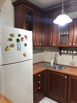 Kitchen with wooden cabinets and a white refrigerator. - image 8