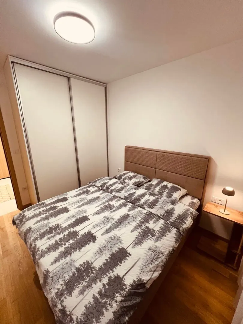Furnished bedroom with a double bed and built-in wardrobe.