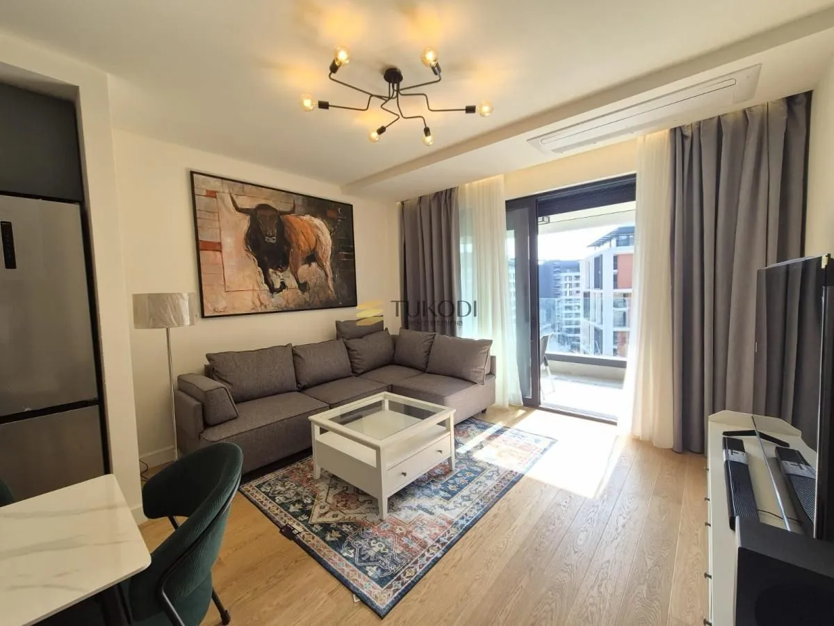 Living room with a sofa, coffee table, and access to the terrace.