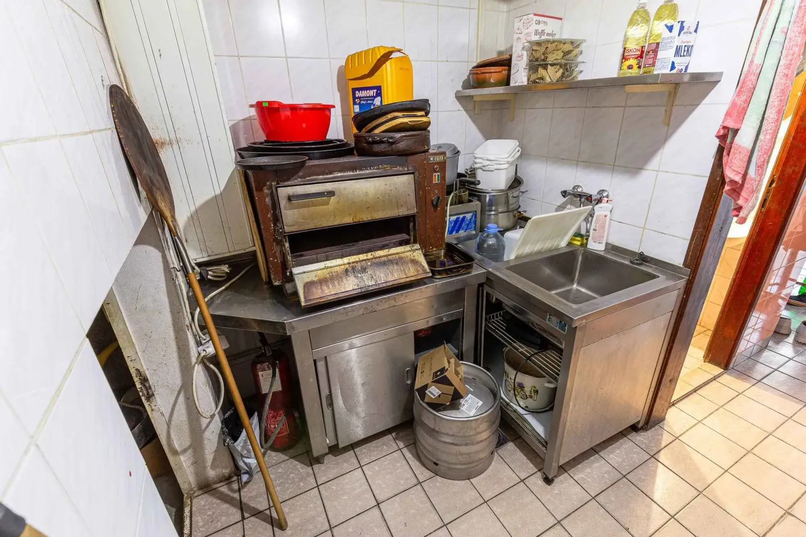 A kitchen work area with stainless steel counters and an oven.