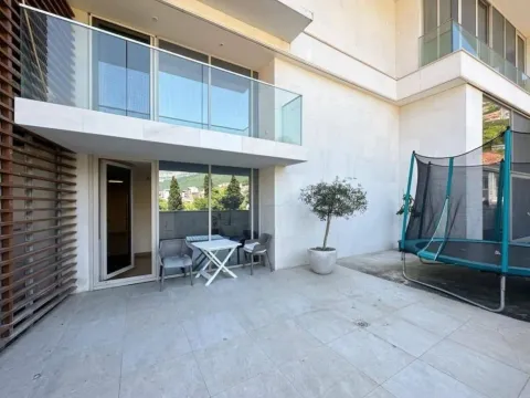 Building courtyard with a paved patio and a trampoline. - image 8