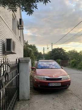 Exterior of a house with a parked car in front of the fence. - image 3