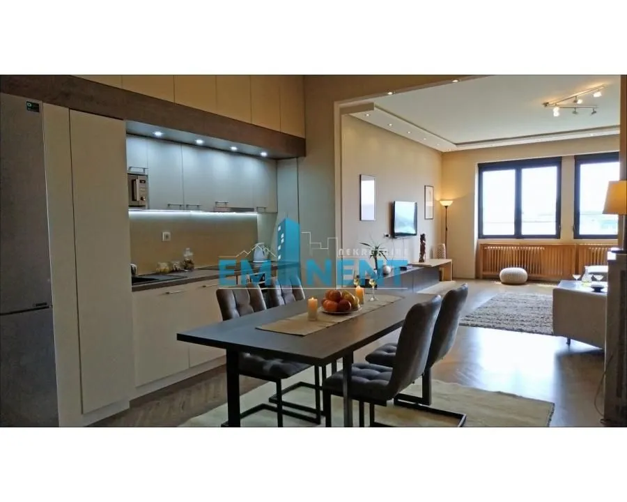 Kitchen with dining area and open view of the living room.