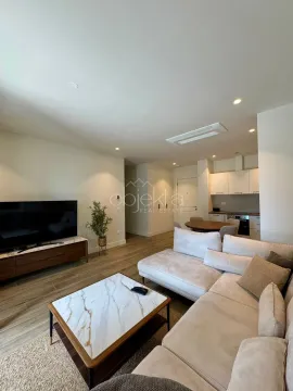 Spacious living room connected to the dining area and kitchen in bright tones. - image 6