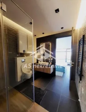Modern bathroom with a shower cabin, washbasin, and toilet. - image 31