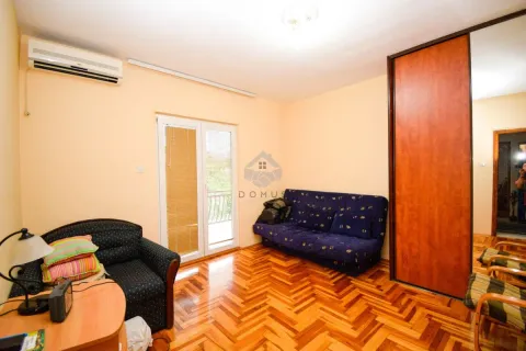 Living room with seating furniture, hardwood floors, and balcony access. - image 13