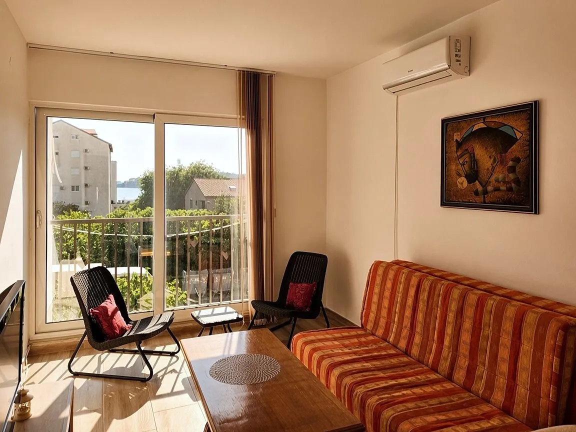 Living room with a sofa set and access to a balcony with a view.