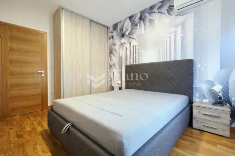 Furnished bedroom with a double bed, wardrobe, and feature wall wallpaper. - image 6