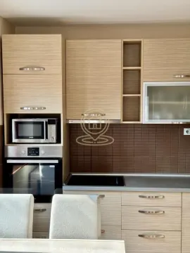 Modern kitchen with wooden cabinets and a built-in oven. - image 6