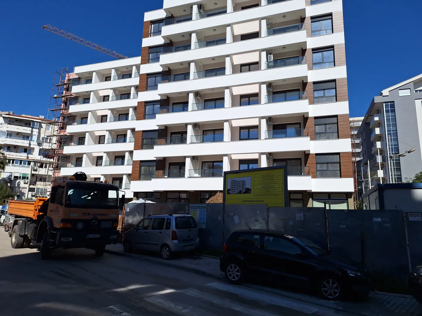 View of a modern residential building under construction with balconies.