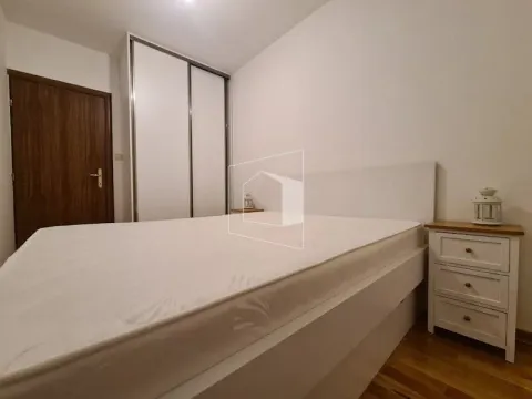 Bedroom with a double bed, wardrobe, and nightstand. - image 9