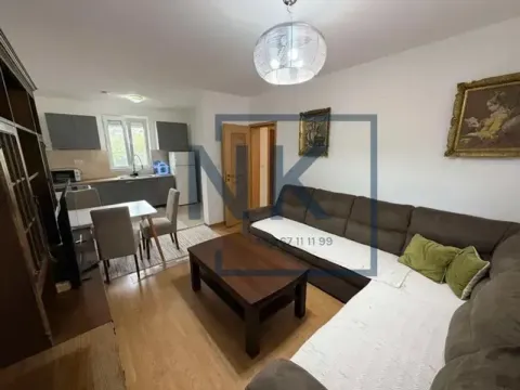 Living room with a sofa set and a dining area in the background. - image 3