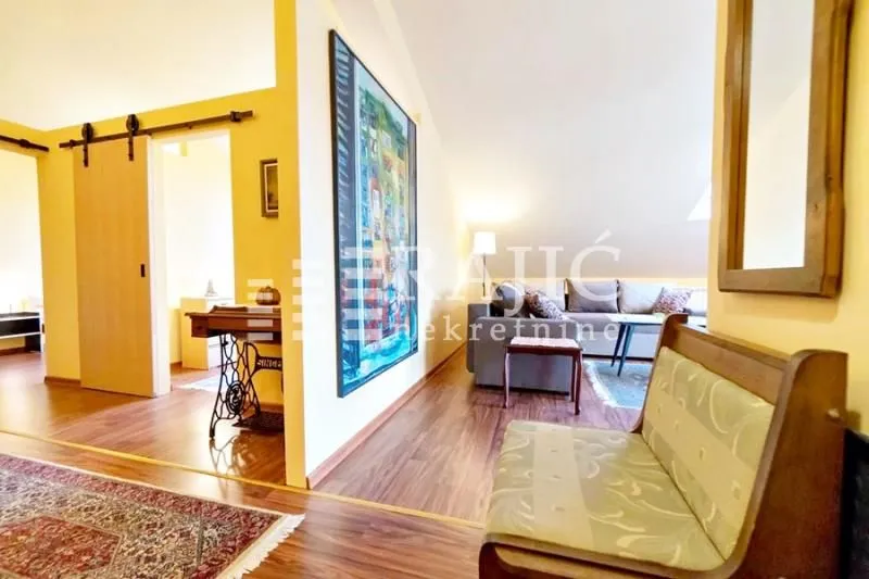 Living room with a sofa and a hallway access.