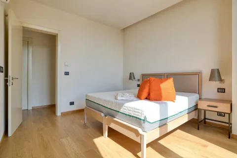 Bright and tidy bedroom with a double bed and wooden flooring. - image 3