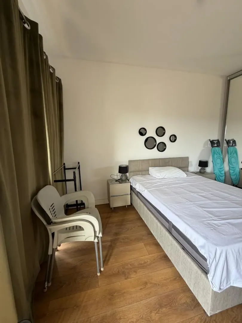 Furnished bedroom with a double bed, nightstands, and a wardrobe.