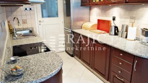 Modern kitchen with wooden cabinetry and granite countertops. - image 6