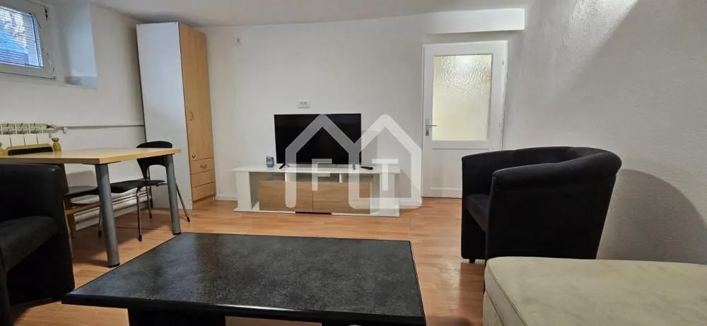 Living room with furniture, television and dining table.