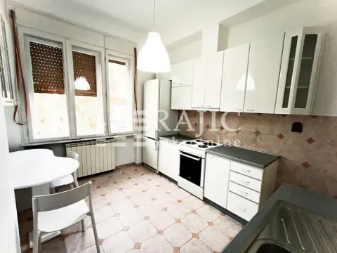 Bright kitchen with white cabinetry and a dining table. - image 14