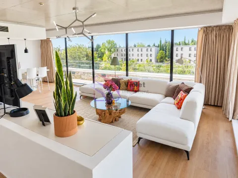 Spacious living room with a large white sofa and a view of greenery. - image 10