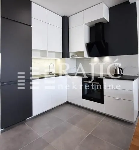 Modern kitchen with white and black elements.