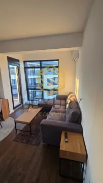 Living room with sofa, coffee table, and access to the terrace. - image 6