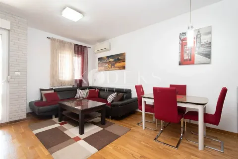 Living room with a corner sofa and a dining table. - image 5