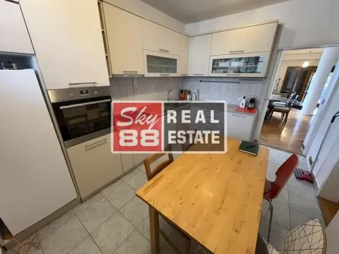 Kitchen with a dining table and built-in appliances. - image 6