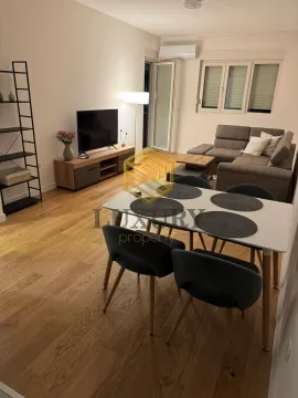Living room with a dining area, sofa, and television. - image 8