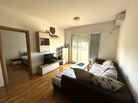 Living room with sofa, TV unit, and access to the terrace. - image 2