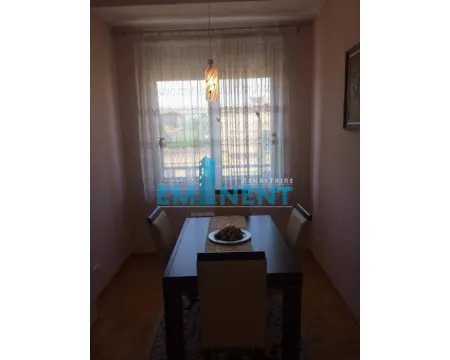 Dining area with a table and chairs in front of the window. - image 4