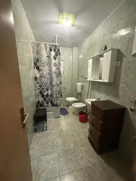 Prikaz kupatila sa keramičkim pločicama, tuš kabinom, sanitarijama i elementima za odlaganje. - image 9