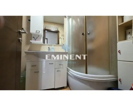 Small bathroom with a washbasin, mirror, and shower cabin. - image 8