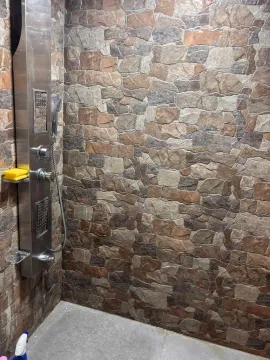Shower enclosure with decorative stone wall cladding. - image 14