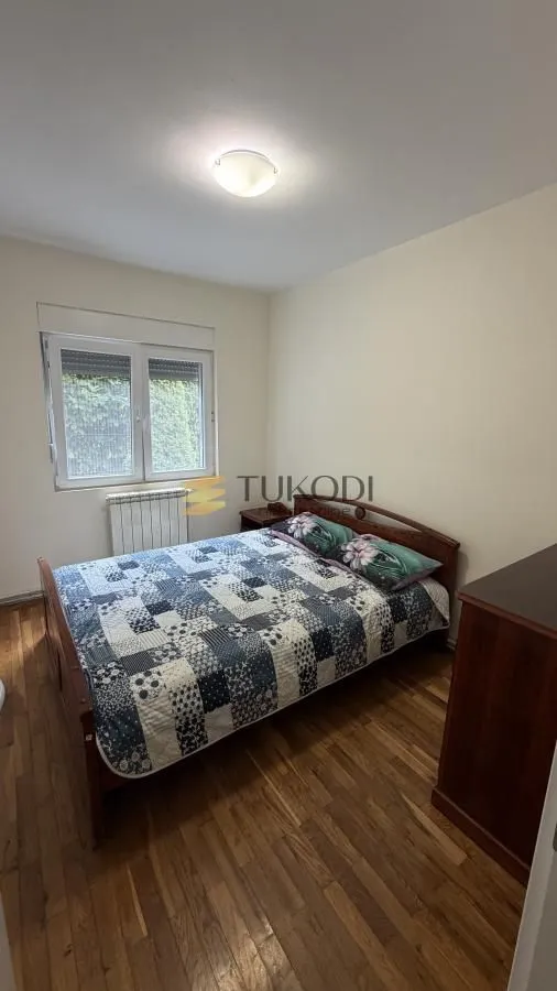 Bedroom with a double bed and wooden flooring.