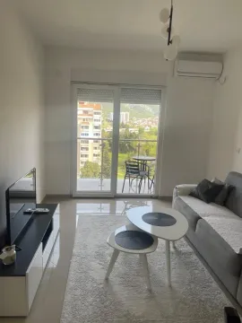 Living room with sofa, coffee table and access to the terrace. - image 2