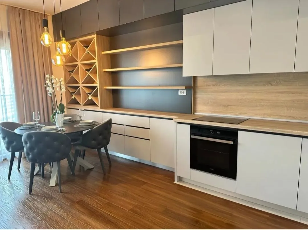 Modern kitchen with dining area and built-in appliances.