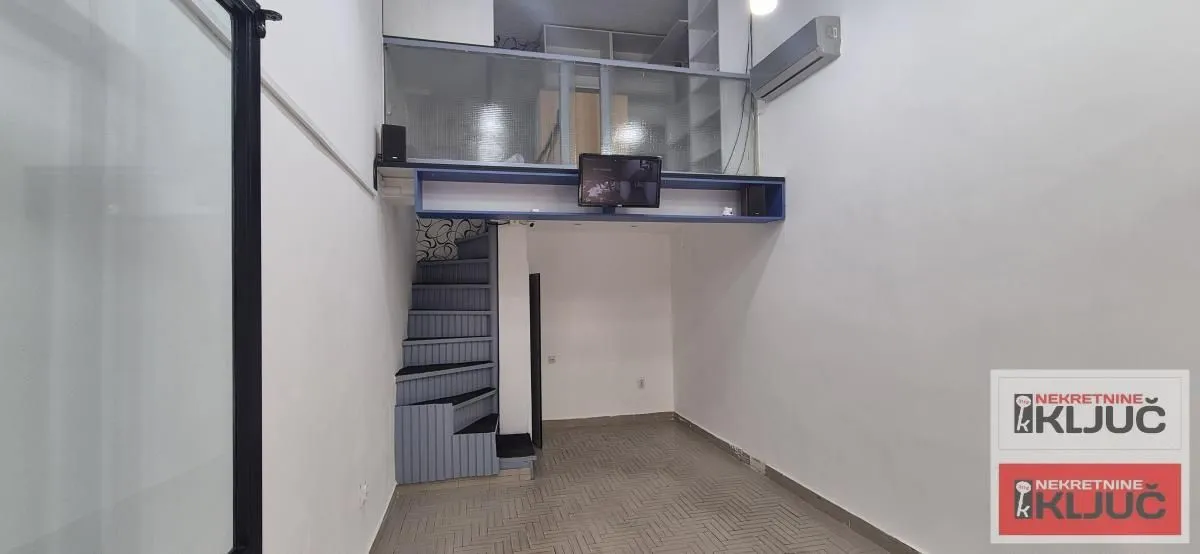Living room with stairs and a gallery in the apartment.