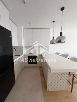 Modern kitchen with white cabinetry and a breakfast bar. - image 5